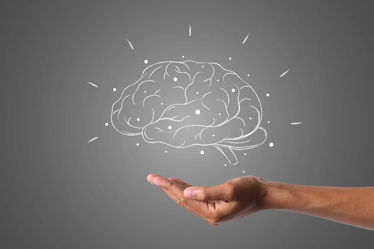Illustration of a brain above an open hand